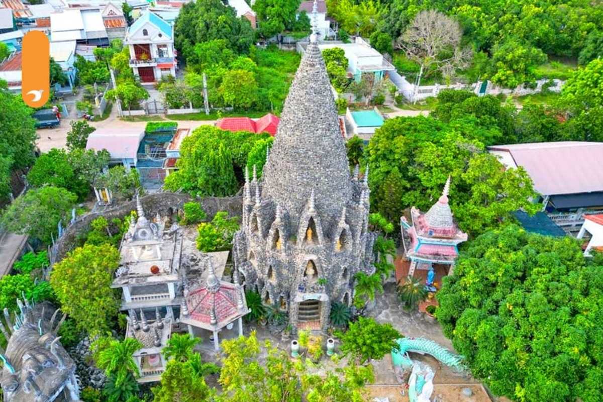 Tu Van Pagoda Nha Trang Stone Tower and Surrounding Temple Complex Stone tower at Tu Van Pagoda surrounded by lush greenery and temple buildings in Nha Trang