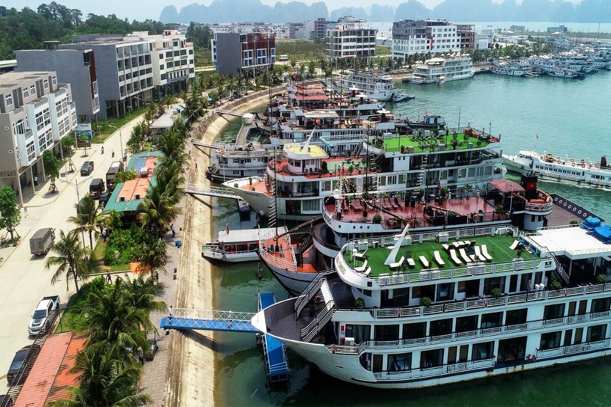Tuan Chau Harbor Halong cruise boats docking Cruise boats docking at Tuan Chau Harbor Halong, ready for visitors to embark on scenic Ha Long Bay tours.