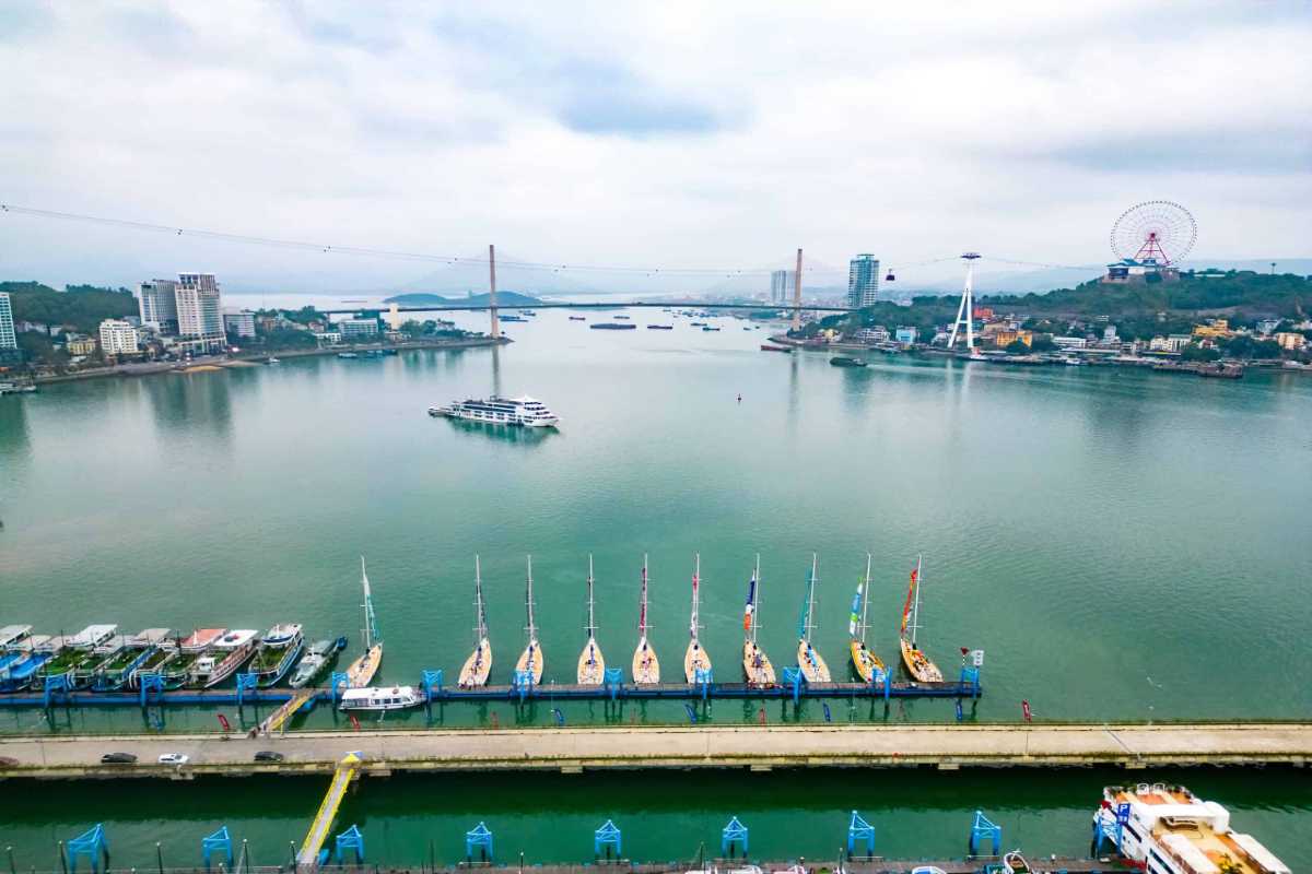 Tuan Chau Harbor Halong panoramic river view Panoramic river view at Tuan Chau Harbor Halong with boats docked and a cable car connecting the city skyline.