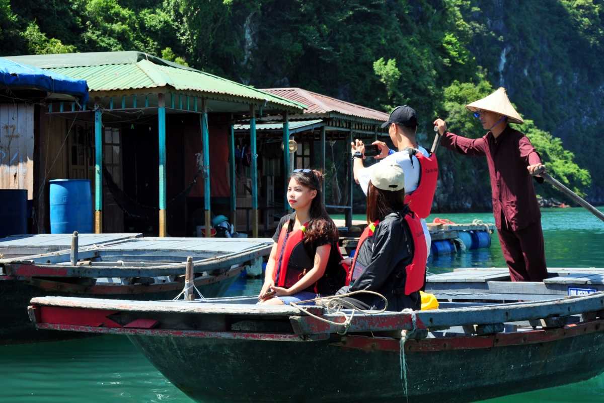 Tung Sau Pearl Farm Halong Bay Visitor Rowing Boats Tourists wearing life jackets on small rowing boats at Tung Sau Pearl Farm Halong Bay surrounded by natural scenery