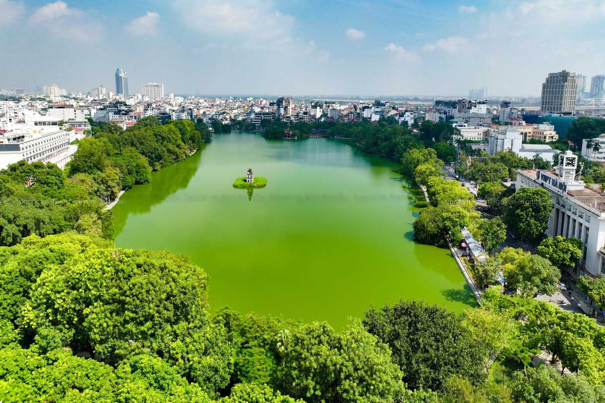 Turtle Tower Hanoi Illuminated at Night Night view of Turtle Tower Hanoi lit up on Hoan Kiem Lake against city lights
