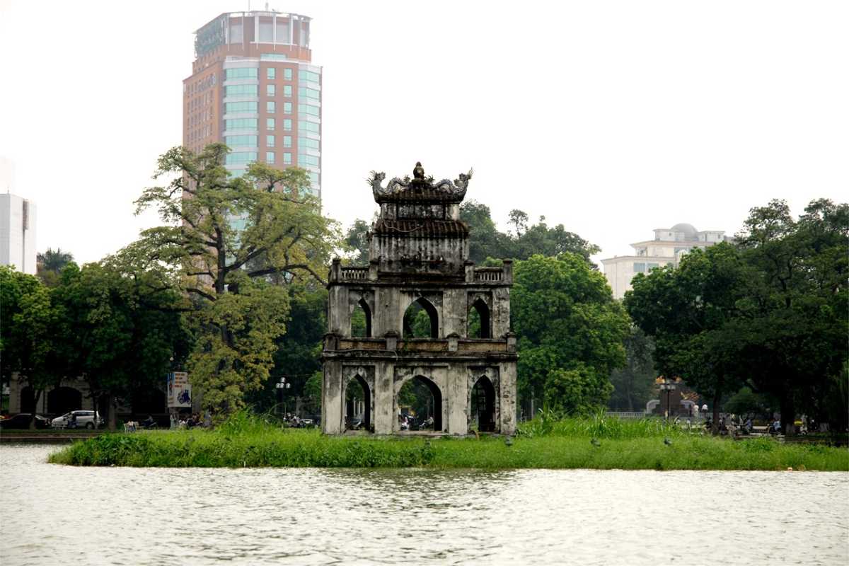 Dramatic Sunset Sky behind Turtle Tower Turtle Tower silhouetted against dramatic orange and purple sunset sky at Hoan Kiem Lake