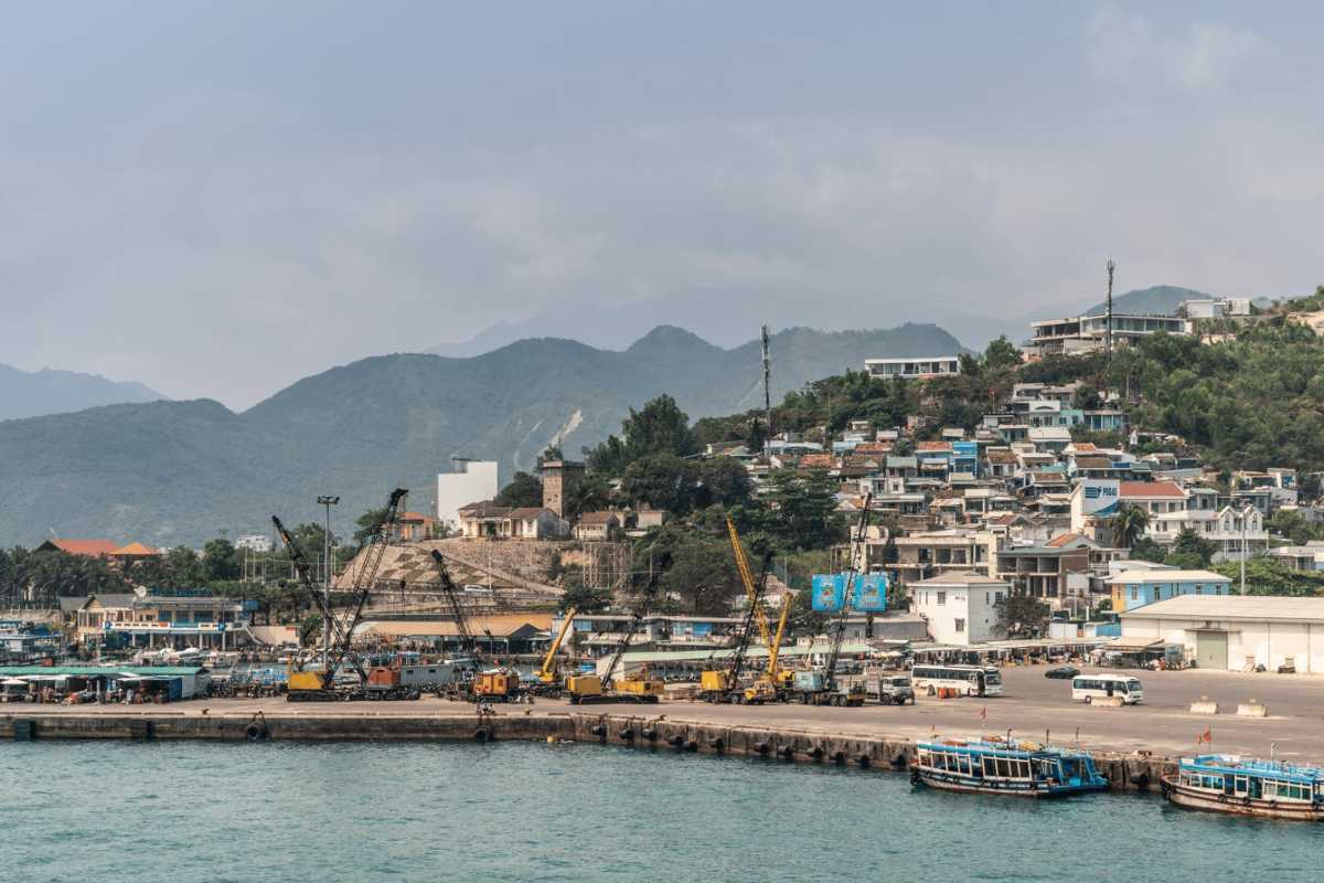 Urban hillside meets Cau Da Port Cau Da Port Nha Trang bordered by hillside homes and port facilities.