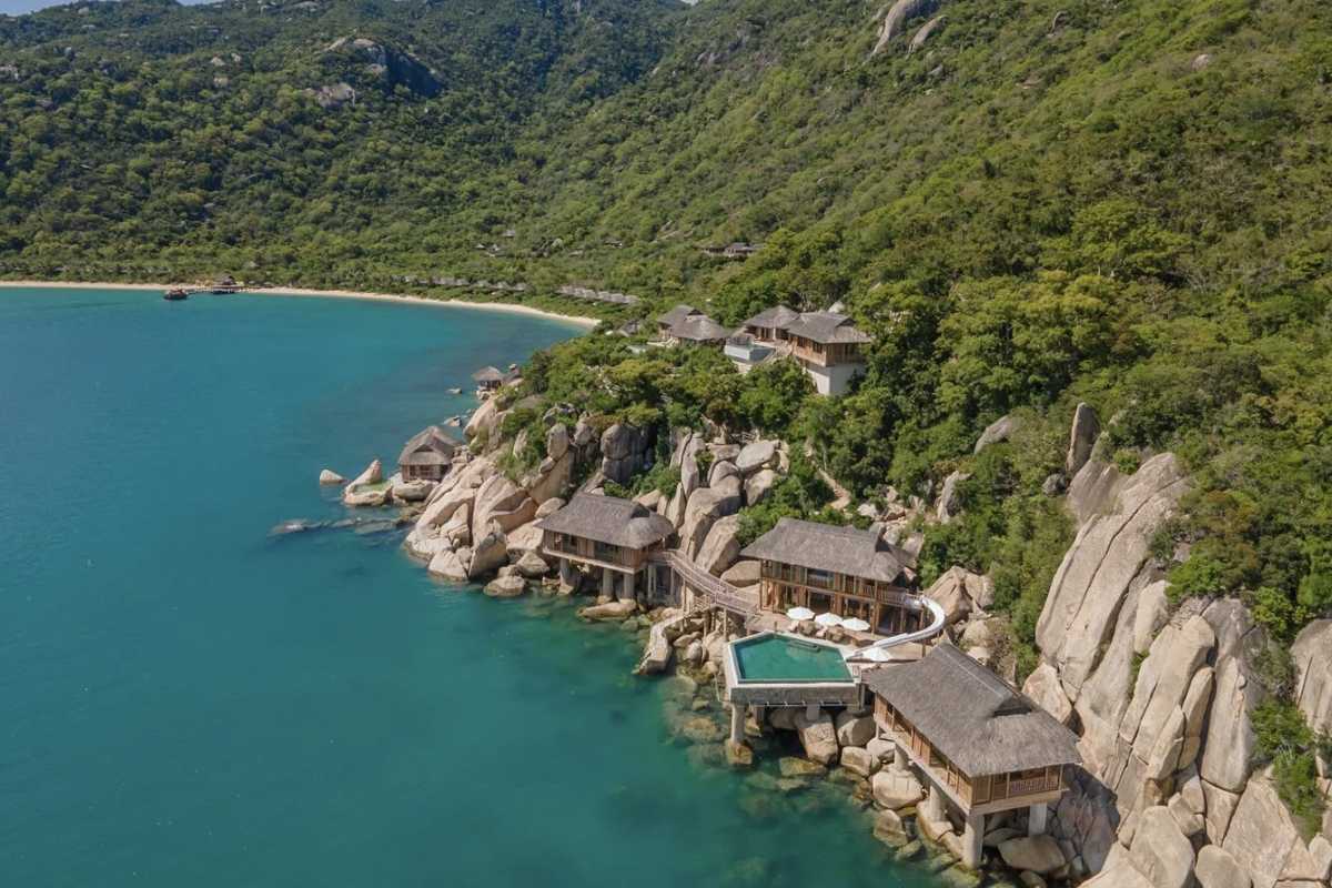 Eco-resort villas built into Van Phong Bay cliffs Hillside eco-resort villas with ocean-facing decks nestled in the rocky coastline of Van Phong Bay