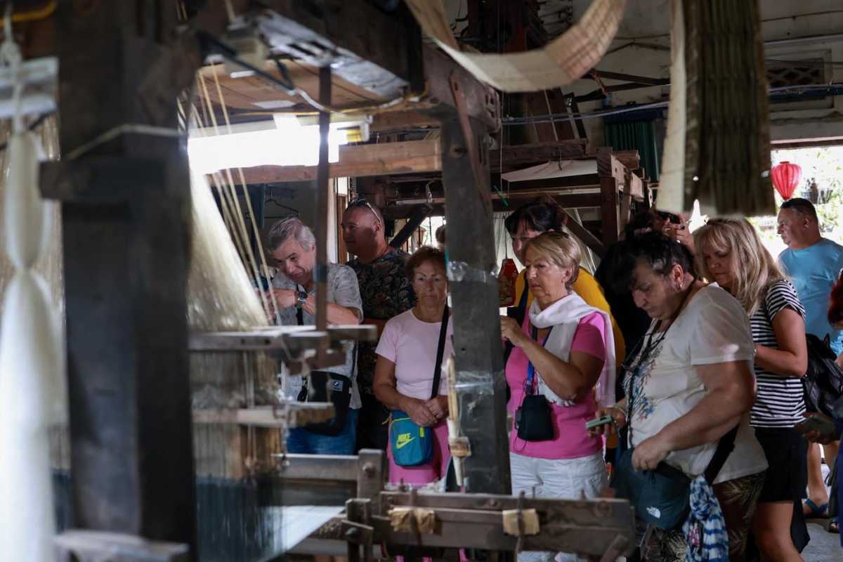 Van Phuc Silk Village Silk Shop Interior Interior view of a silk shop showing hanging Ao Dai and silk garments at Van Phuc Silk Village.
