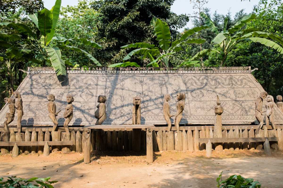 Vietnam Museum of Ethnology Hanoi ethnic wooden statues exhibit Vietnam Museum of Ethnology Hanoi outdoor exhibit of carved wooden statues representing ethnic traditions and rituals.