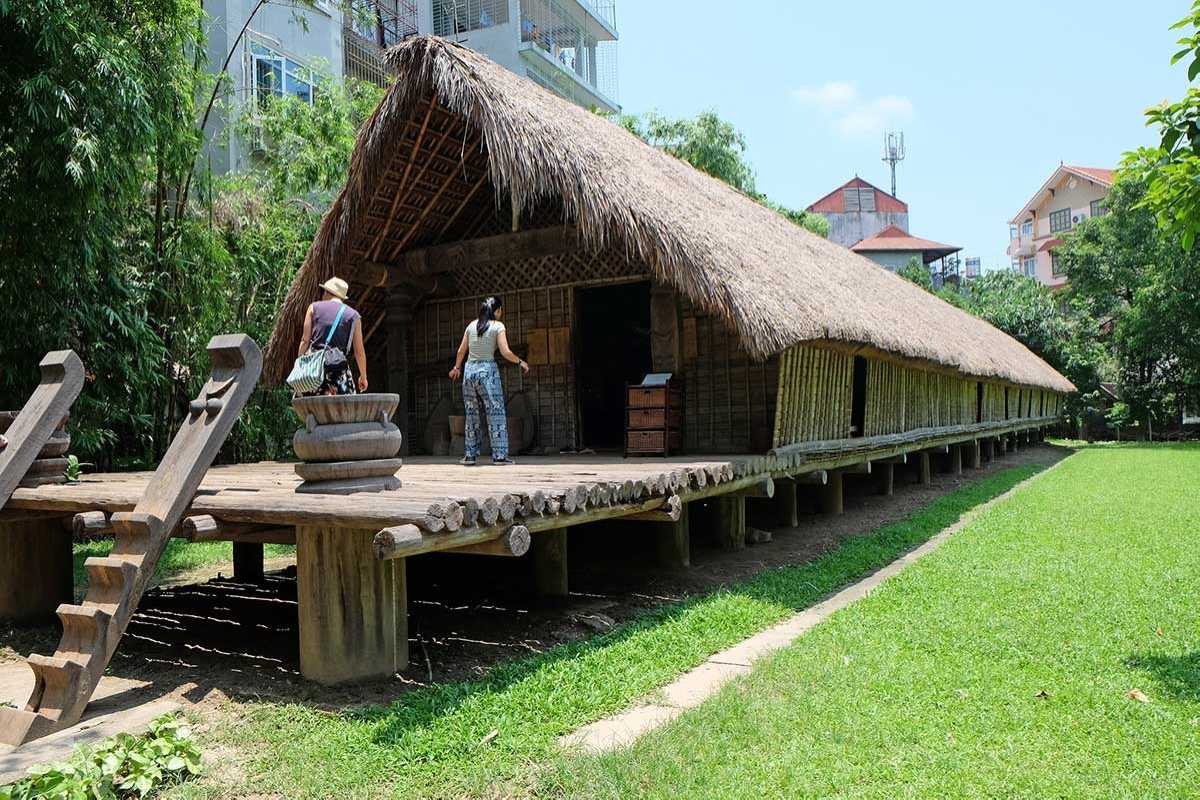 Vietnam Museum of Ethnology Hanoi indoor traditional costumes exhibit Vietnam Museum of Ethnology Hanoi indoor exhibit featuring traditional ethnic costumes and textiles with detailed design.
