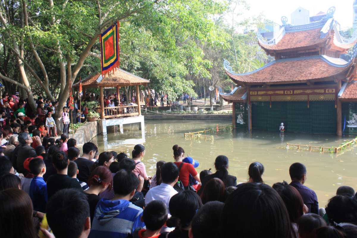 Vietnam Museum of Ethnology Hanoi stilt house and village pathway Vietnam Museum of Ethnology Hanoi traditional stilt house with wooden fences and garden pathways in an ethnic village.