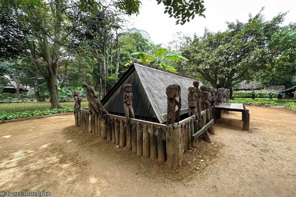 Vietnam Museum of Ethnology Hanoi traditional communal house model Vietnam Museum of Ethnology Hanoi large communal house model with tiled roof and open courtyard for ethnic gatherings.