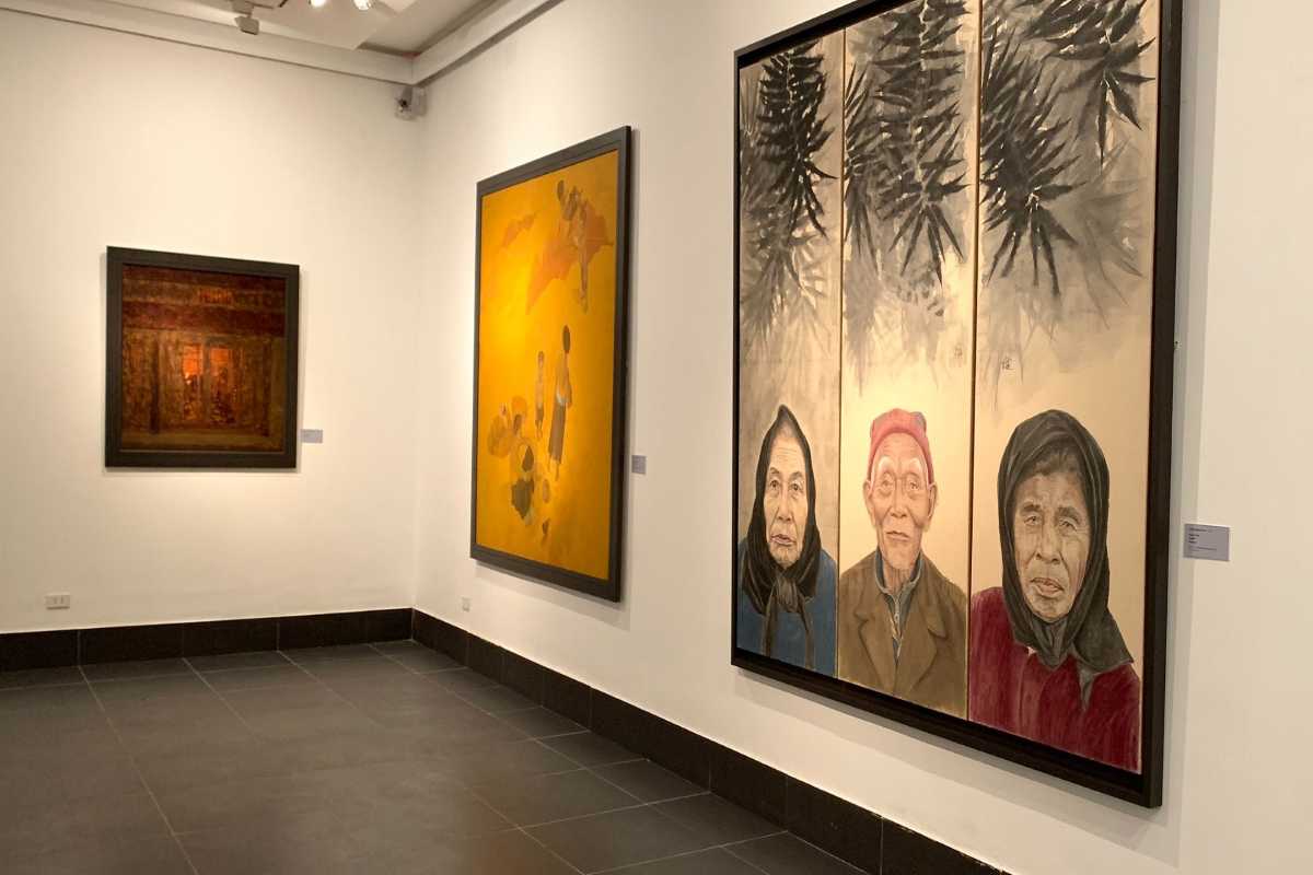 Vietnamese Cultural Art Display with Visitors Visitors exploring colorful cultural artworks at Vietnam National Fine Arts Museum