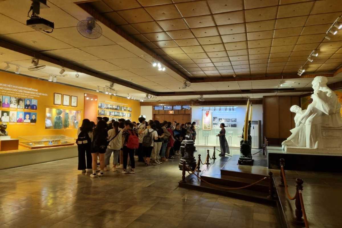 Vietnamese Women’s Museum Main Exhibition Hall Visitors exploring the main exhibition hall filled with sculptures and displays