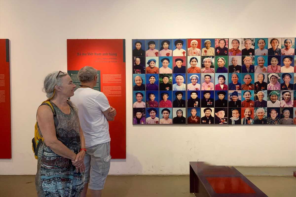 Vietnamese Women’s Museum Visitor Experience Visitors interacting with museum exhibits in a bright, modern gallery space