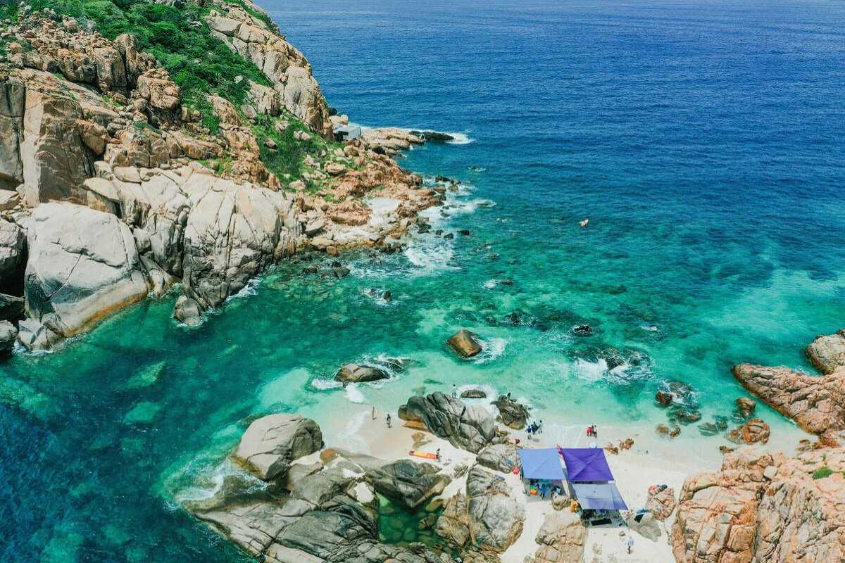 Vinh Hy Bay coastal road winding through mountains Coastal road winding through green mountains along Vinh Hy Bay, great for scenic drives
