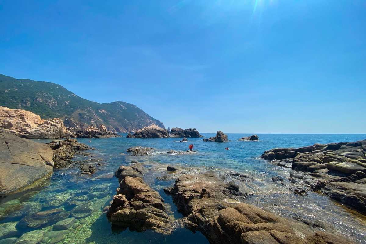 Vinh Hy Bay crystal clear waters with rocky coastline Crystal clear waters and rugged rocky coastline at Vinh Hy Bay, a natural marine haven