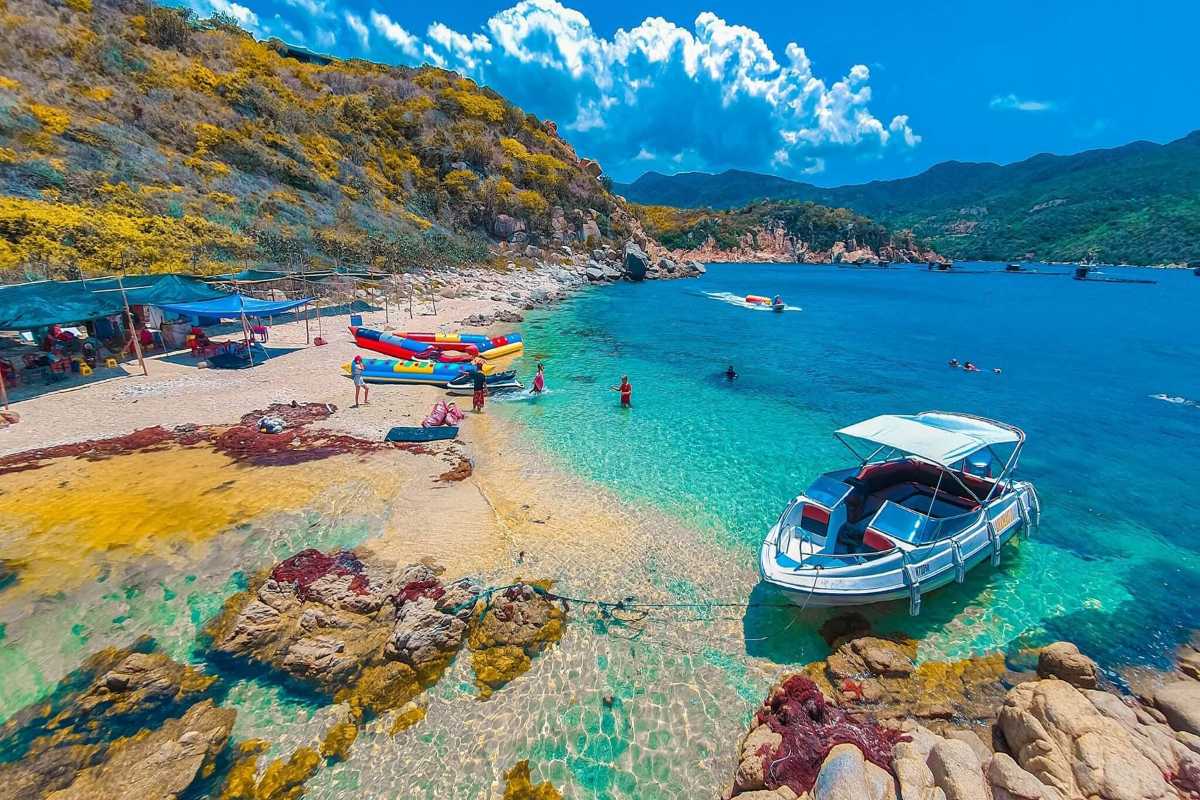 Vinh Hy Bay vibrant fishing boats in calm bay waters Colorful fishing boats floating peacefully in the calm waters of Vinh Hy Bay