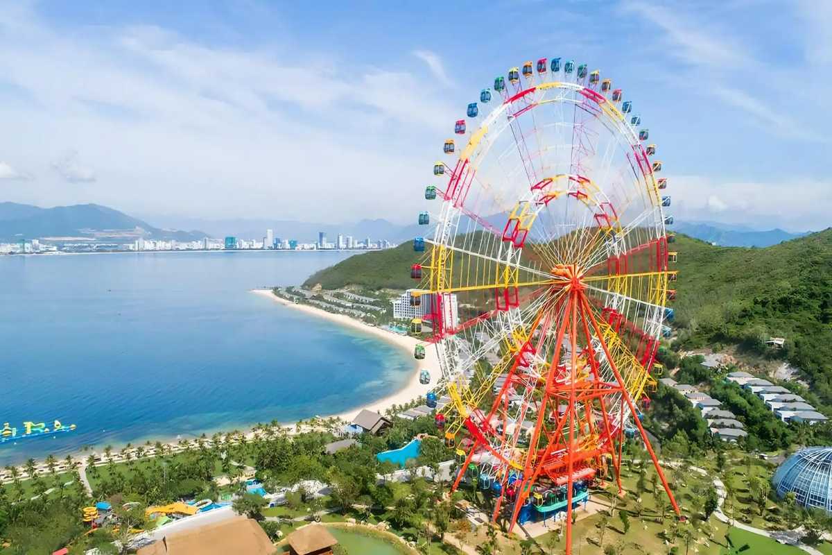 VinWonders Ferris Wheel and Beach View Large ferris wheel overlooking the Nha Trang coast with beach and city skyline in the background