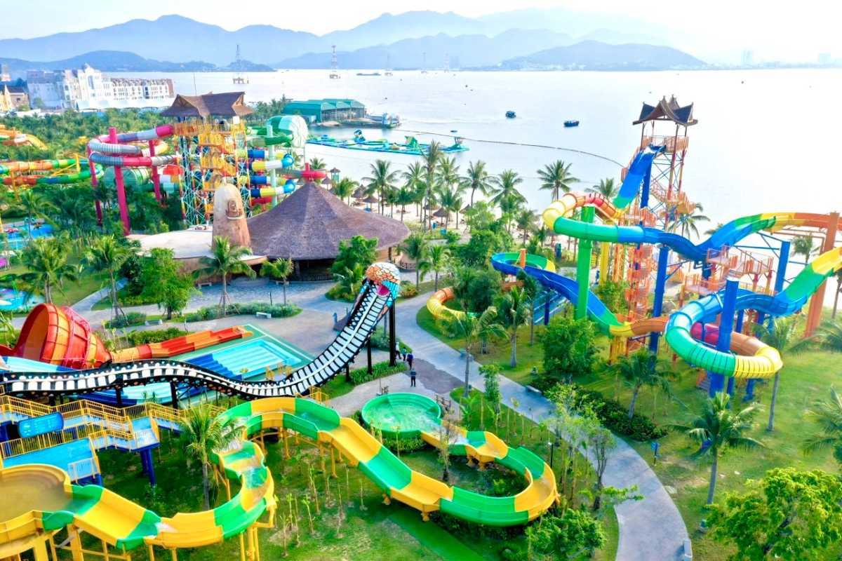 Water Slide Tower and Beachside View at VinWonders Brightly colored water slides winding down from a tower next to the sea at VinWonders Nha Trang