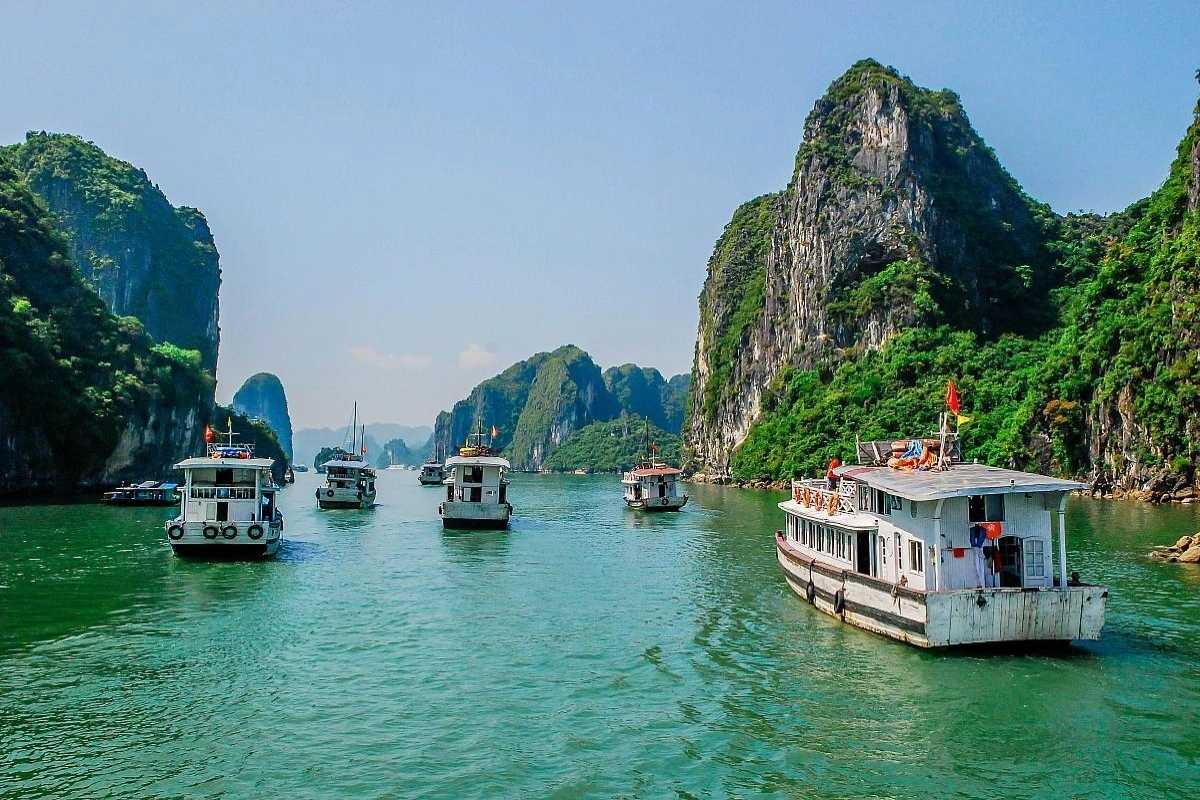Virgin Cave Halong Bay cave entrance and limestone cliffs View of Virgin Cave Halong Bay entrance with towering limestone cliffs and natural rock