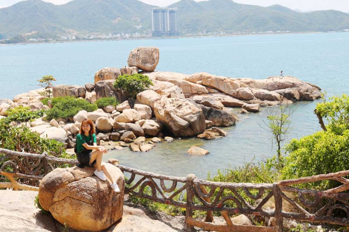 Visitor Enjoying Da Chong Wharf Nha Trang Tourist overlooking Da Chong Wharf and ocean, enjoying coastal scenery in Nha Trang