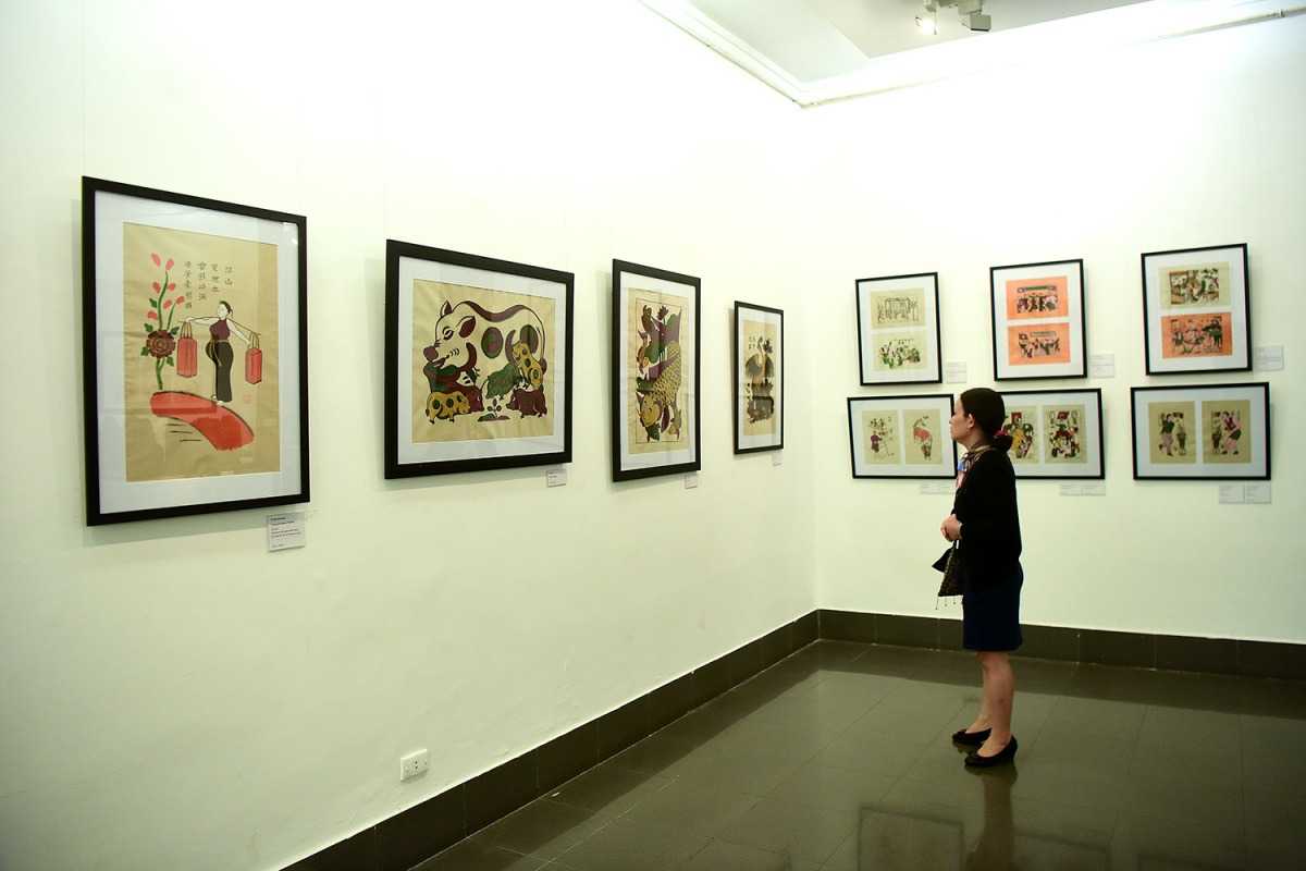 Art Gallery with Visitors and Sculptures Visitors viewing sculptures and paintings inside Vietnam National Fine Arts Museum gallery