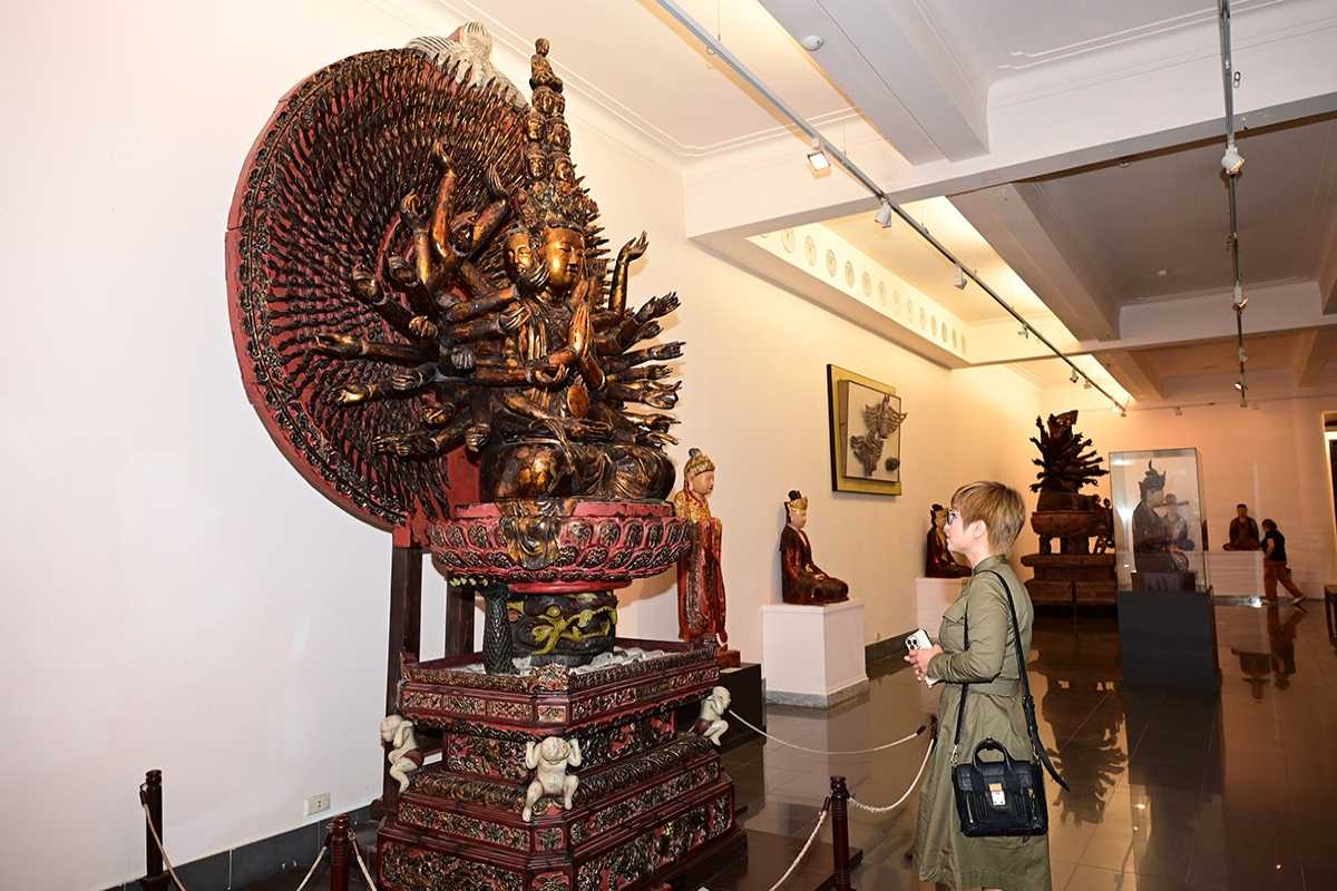 Two Visitors Discussing Artworks in Museum Two visitors discussing paintings inside Vietnam National Fine Arts Museum
