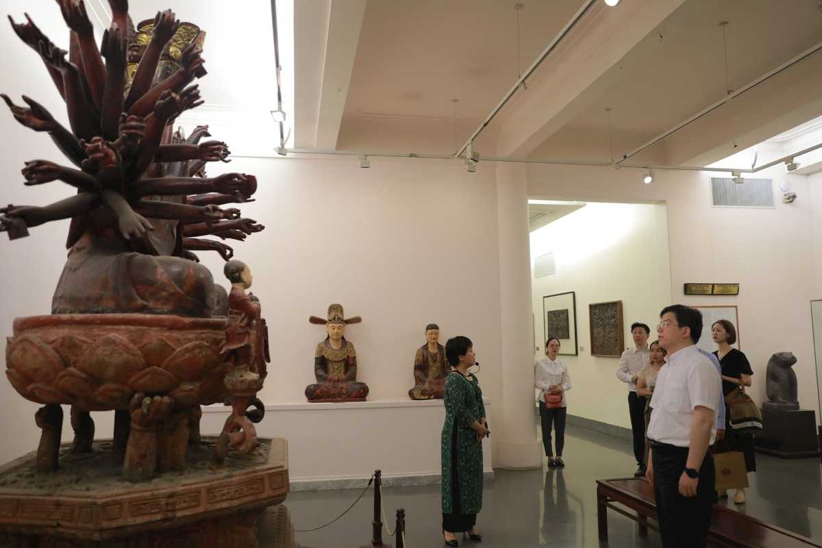 Visitor Viewing Paintings in National Fine Arts Museum Visitors appreciating paintings inside the Vietnam National Fine Arts Museum