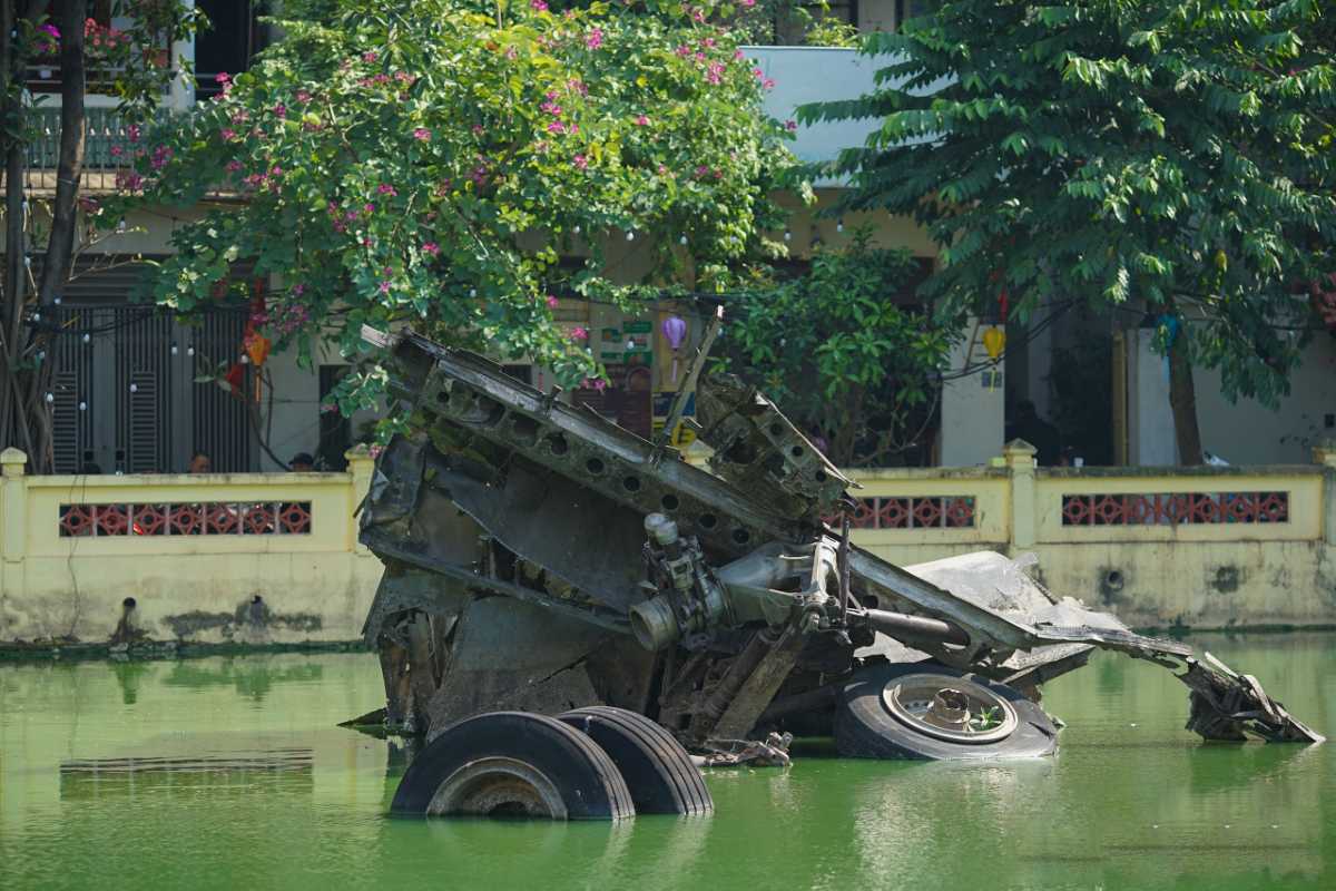 Warplane Wreckage and Memorial in Huu Tiep Lake Warplane wreckage next to the historic memorial in Huu Tiep Lake Hanoi with lush trees and urban buildings