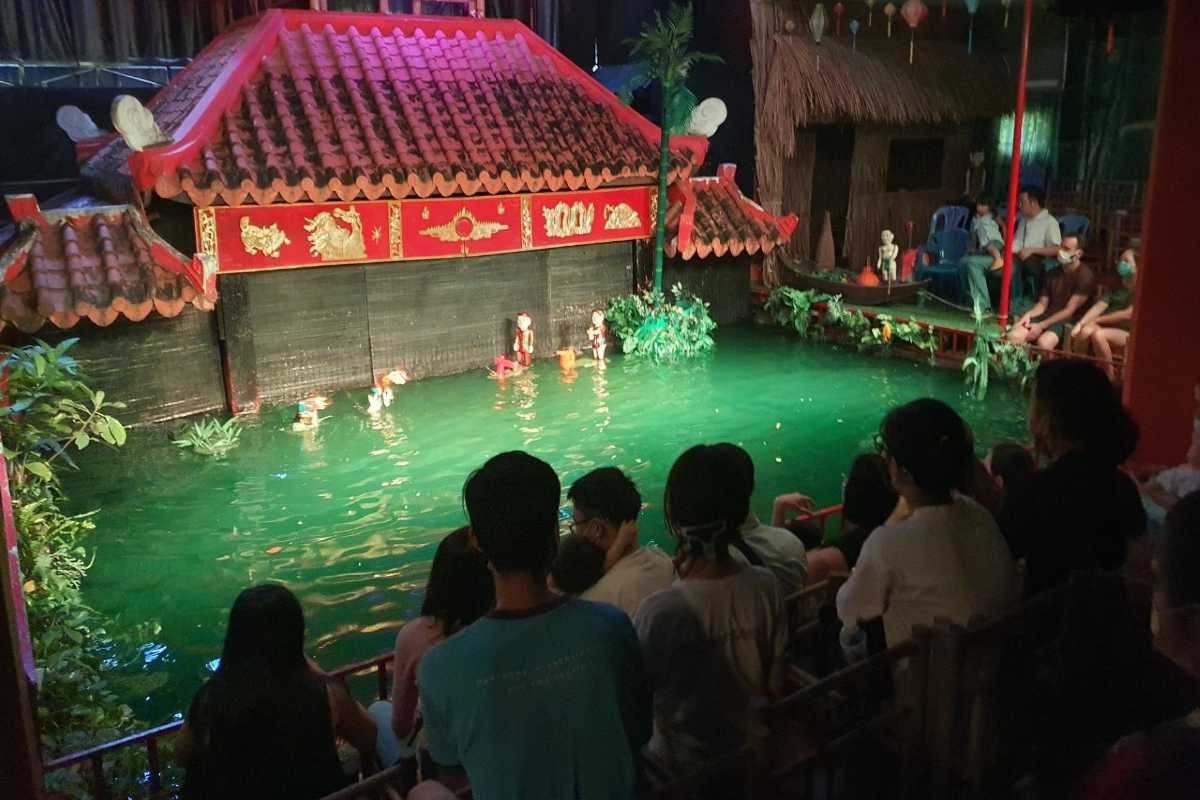 Scene of Water Puppets with Buffalo and Farmers Water puppets depicting farmers and buffalo in a traditional Vietnamese rural scene
