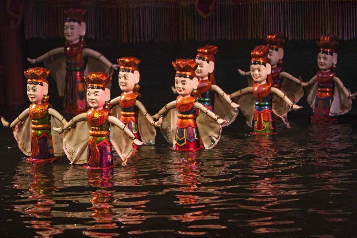 Water Puppets Performing a Ceremonial Scene Puppets performing a ceremonial dance with candles on the water stage