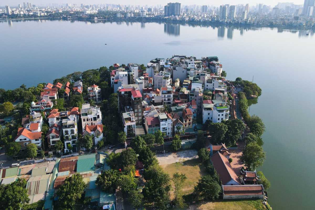 West Lake Hanoi Scenic Urban View Aerial view of West Lake Hanoi surrounded by urban buildings, showcasing the tranquil water and city skyline