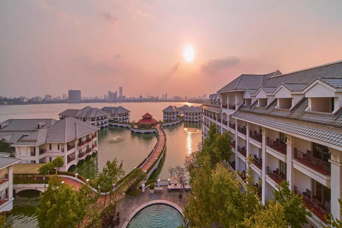 West Lake Hanoi Twilight Glow Twilight glow over West Lake Hanoi with colorful sky and calm water, blending natural and urban beauty