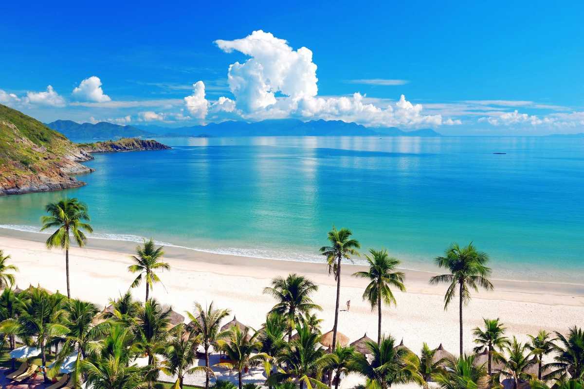 White sand beach with palm trees on Thi Island White sand beach with palm trees along the coastline of Thi Island Nha Trang