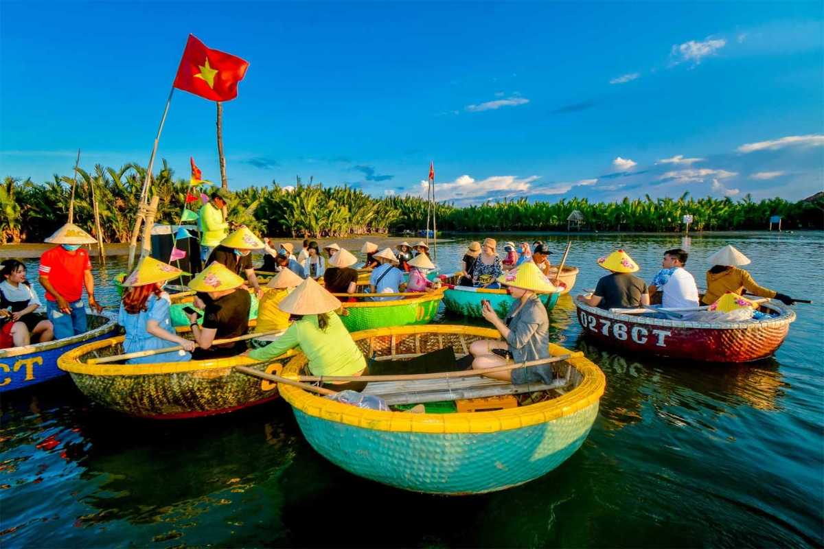 Wide Aerial Shot of Basket Boats in River Channels Wide aerial shot of basket boats floating through green waterways lined with coconut palms