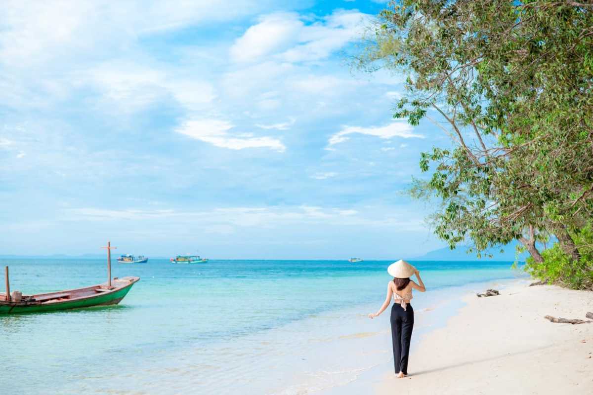 Woman Walking Along Long Beach Phu Quoc A woman walking along the beautiful Long Beach (Bãi Dài) in Phu Quoc.