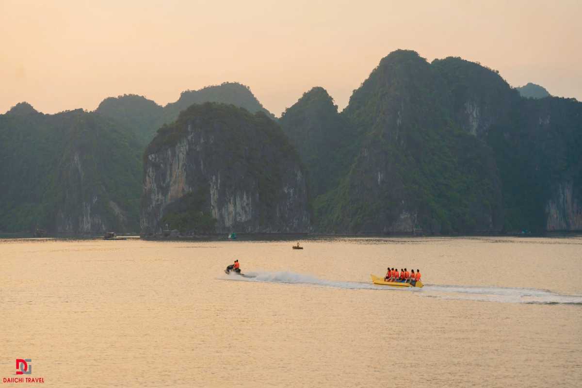Traditional junk boat sailing in Xep Islet Halong Bay Traditional junk boat with brown sails cruising the emerald waters of Xep Islet Halong Bay amidst limestone islands.