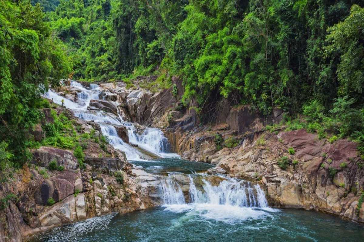 Scenic view of Yang Bay Waterfall levels Multiple rock tiers of Yang Bay Waterfall cascading down through a forest valley