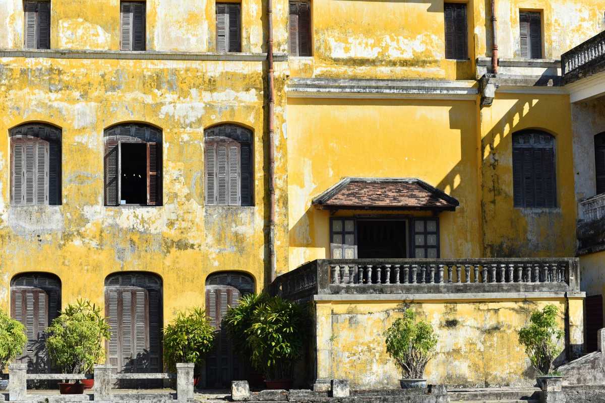 Yellow Facade of An Dinh Palace in Hue Yellow facade with multiple windows and balcony of An Dinh Palace in Hue