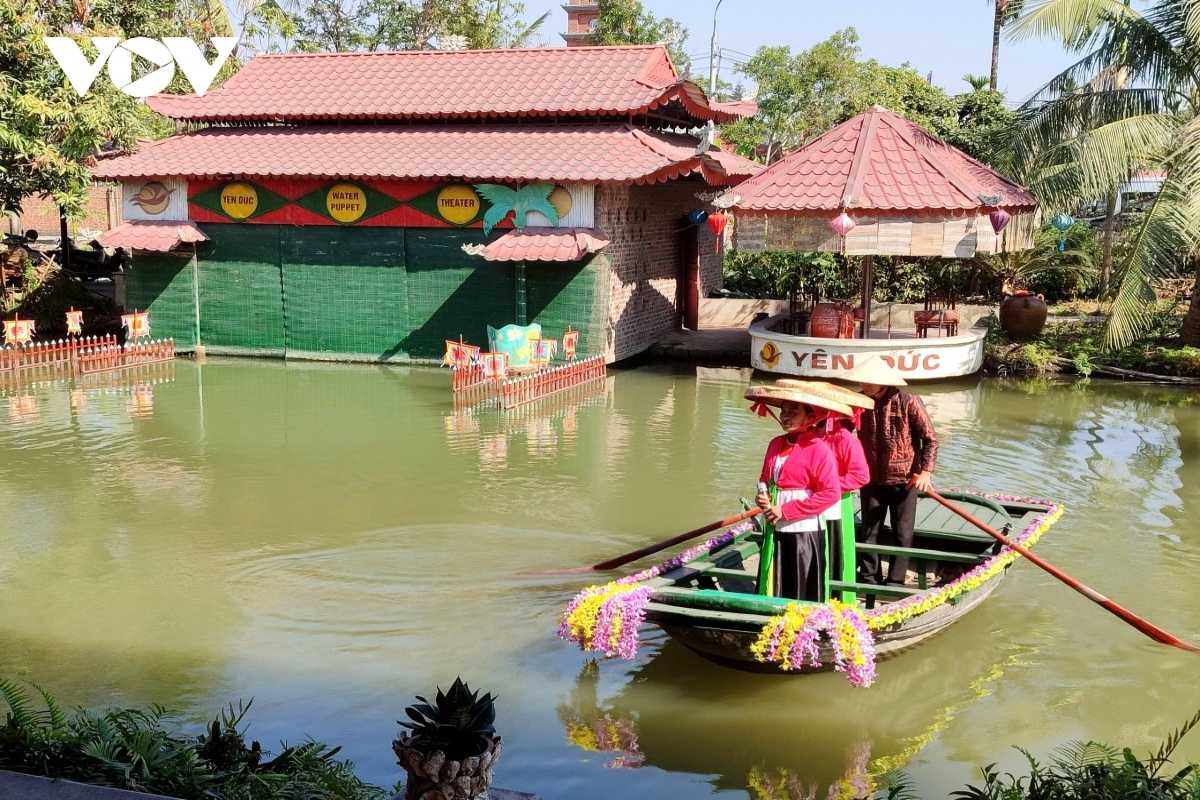 Boat Ride at Yen Duc Village Water Puppet Theater Pond Visitors enjoying a decorated boat ride in the scenic pond of Yen Duc Village water puppet theater.