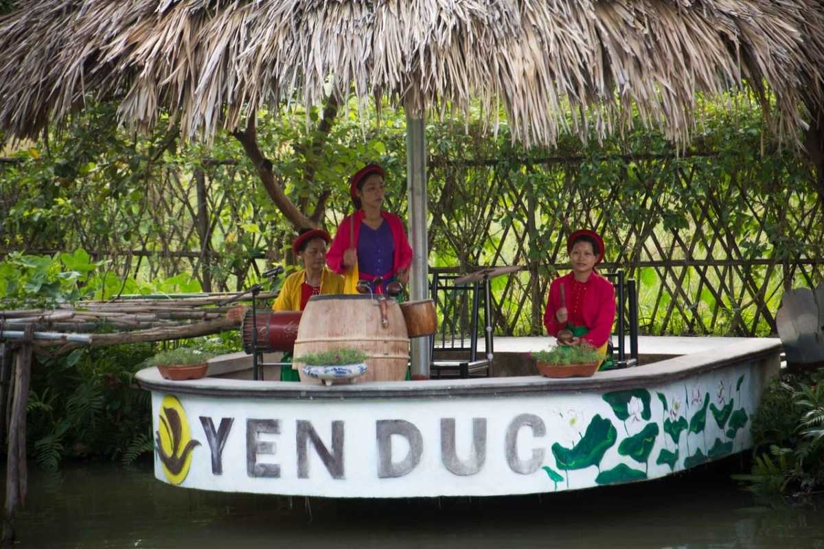 Yen Duc Village Cultural Water Puppet Performance Traditional water puppet performance at Yen Duc Village with local performers in colorful costumes on a pond stage.