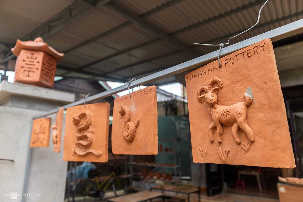 Traditional Zodiac-Themed Terracotta Tiles at Thanh Ha Terracotta zodiac tiles hanging for display at Thanh Ha Pottery Village, representing cultural symbols