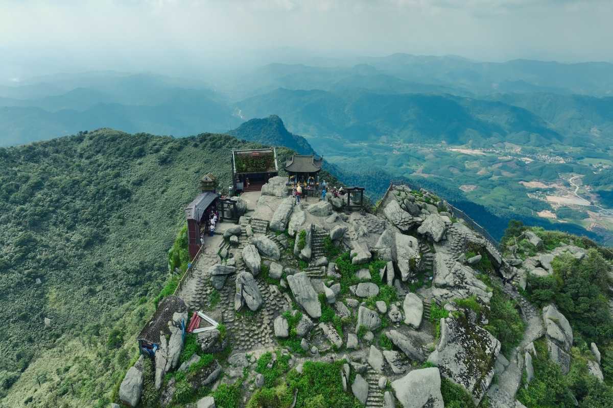 Bac Giang Travel Aerial View of Mountain Peak and Valley Bac Giang Travel shows an aerial shot of rugged mountain peaks overlooking lush green valleys