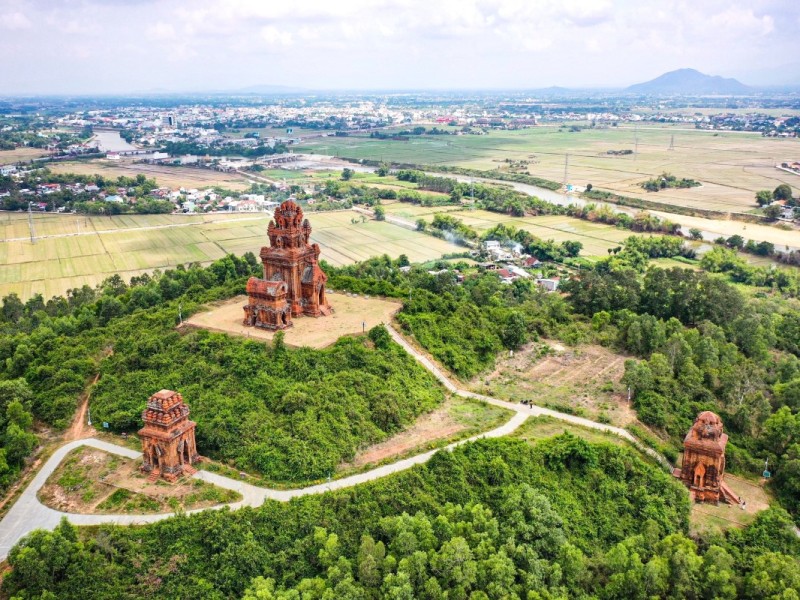 Aerial view of the ancient Banh It Towers in Binh Dinh Province surrounded by lush greenery