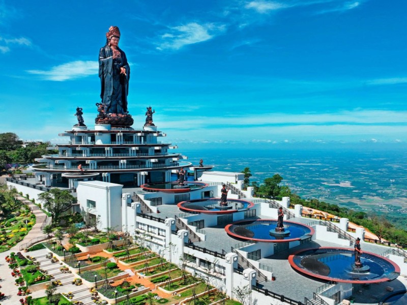 A grand Buddhist statue at the summit of Ba Den Mountain, standing tall over the Tay Ninh landscape.