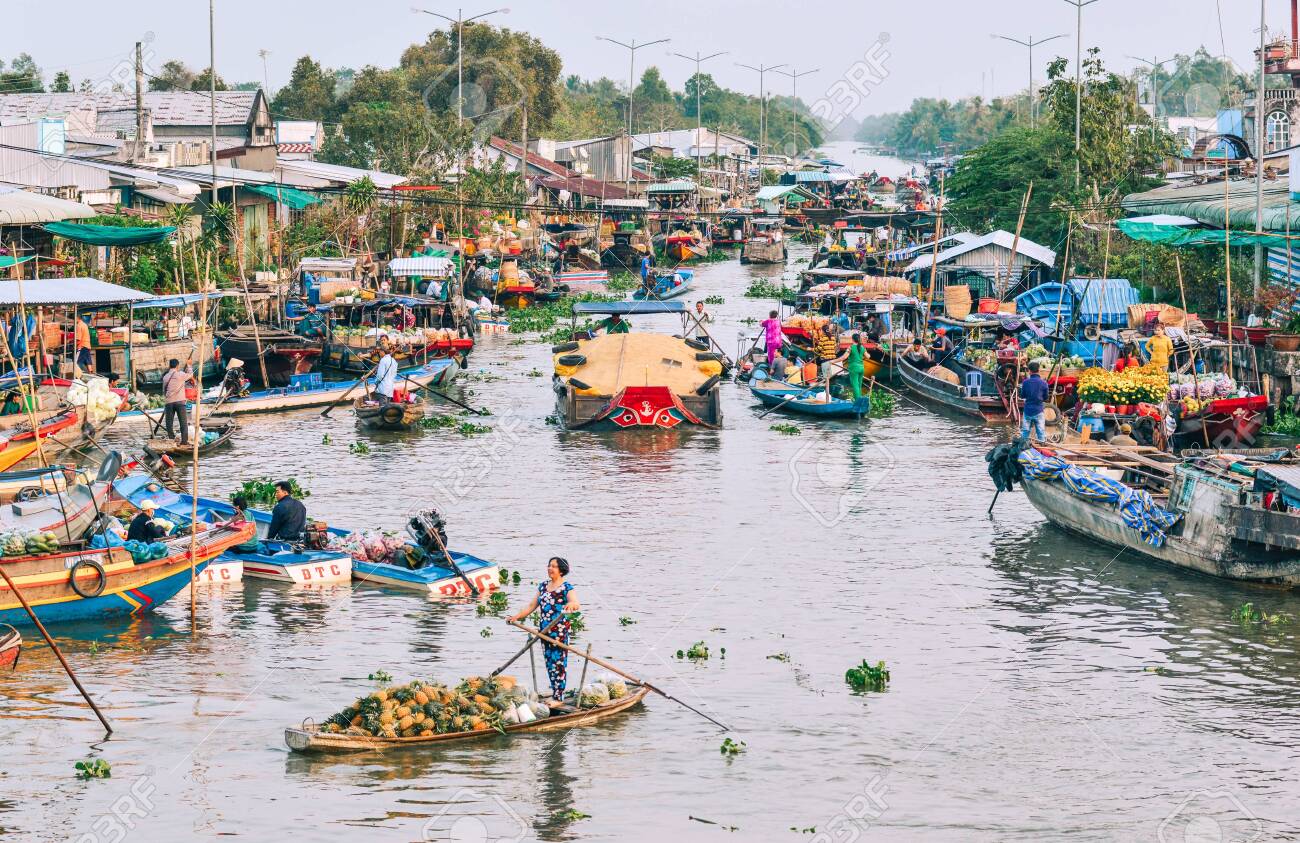 A vibrant image of Cai Be Floating Market in Tien Giang featuring boats filled with fruits, vegetables, and local products.