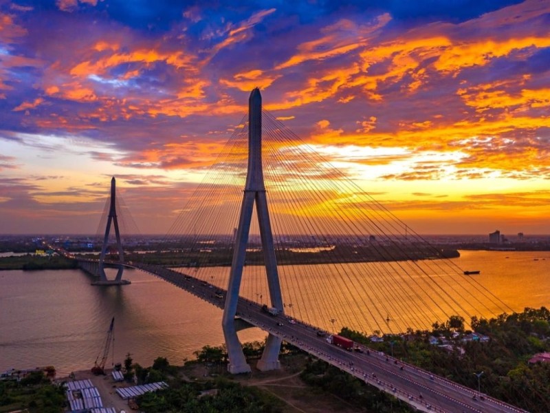 Can Tho Bridge at sunset, connecting Mekong Delta with a stunning sky in the background.