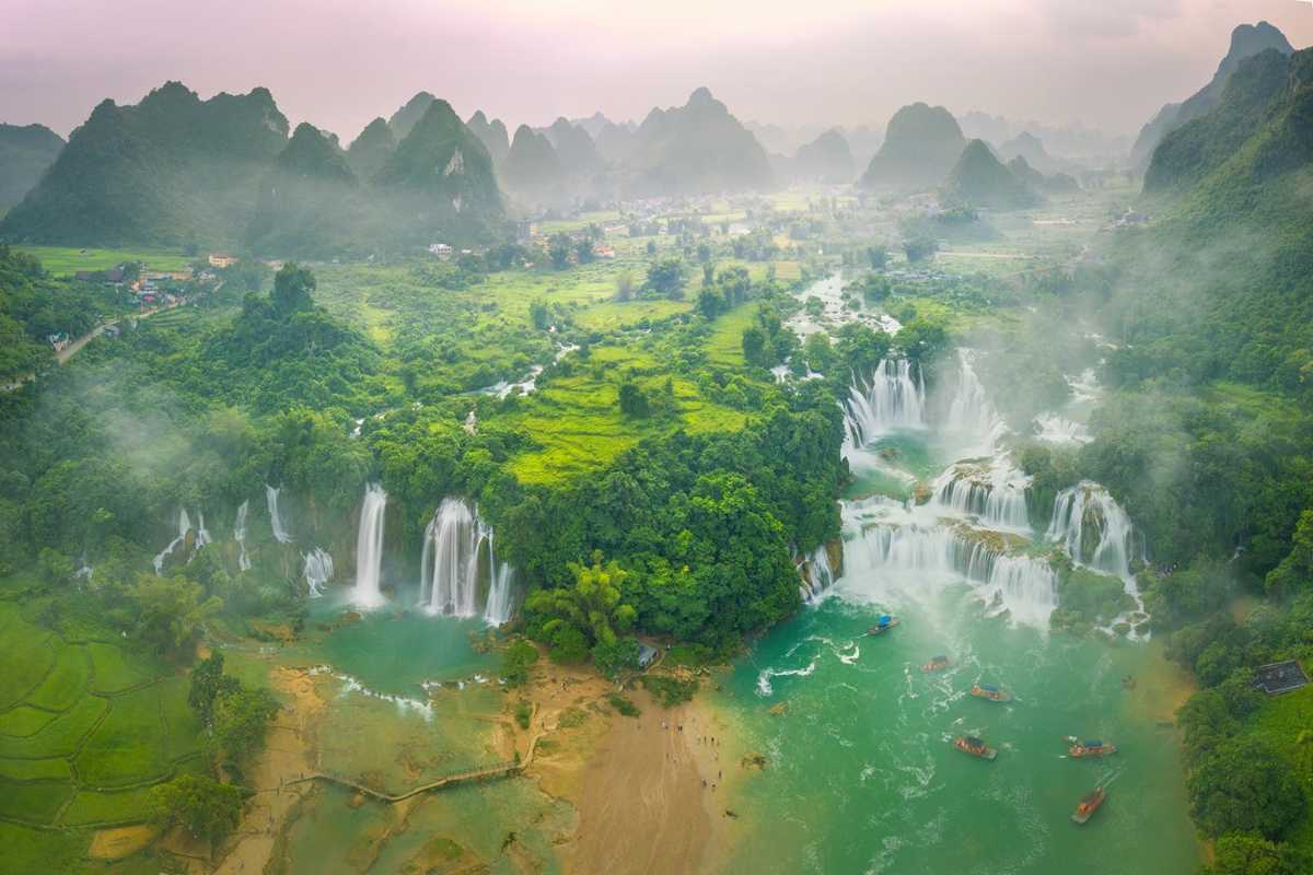 Cao Bang Travel Guide Aerial View Ban Gioc Waterfall Aerial shot of Ban Gioc Waterfall cascading into emerald pools surrounded by dense forest in Cao Bang province