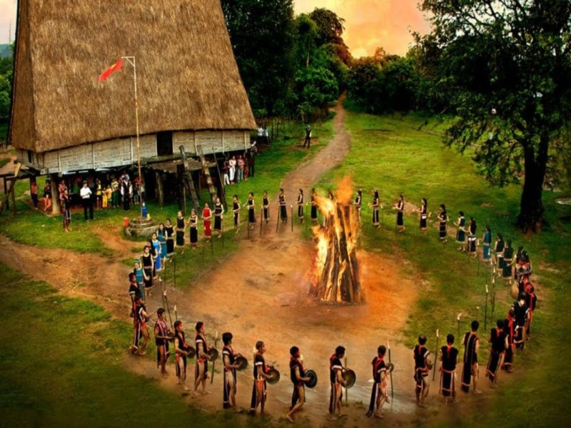 Cultural gathering around a bonfire at the Kon Tum Communal House in Vietnam