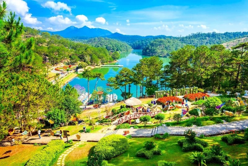 A beautiful garden and lake in Da Lat surrounded by lush greenery and hills