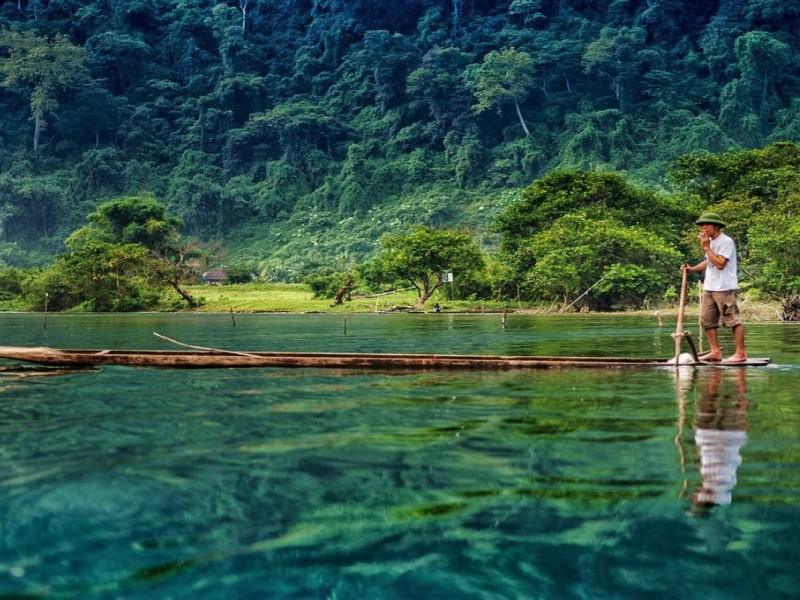 Local fisherman paddling on Ba Be Lake in Bac Kan