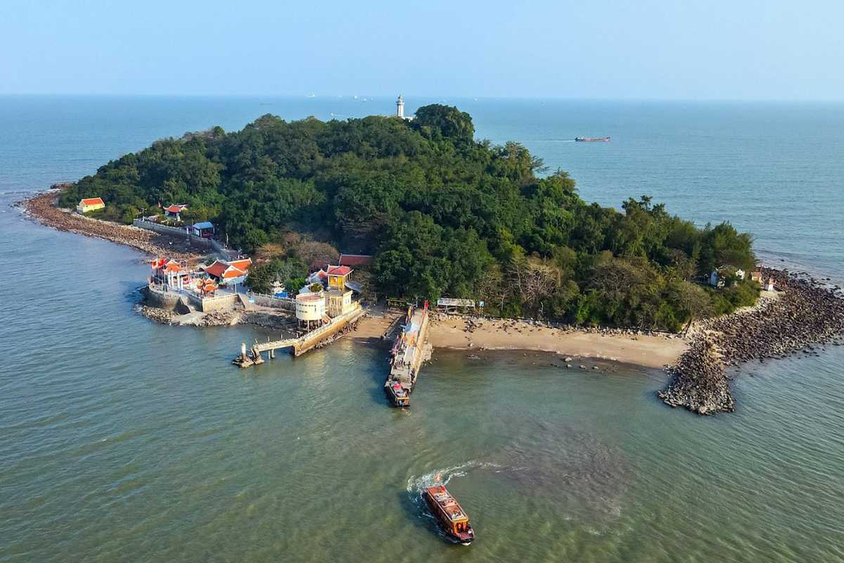 Aerial view of Hai Phong bay with limestone islands and urban parks Bird’s-eye view of Hai Phong bay showcasing limestone islands, city parks, and waterways in a balanced landscape
